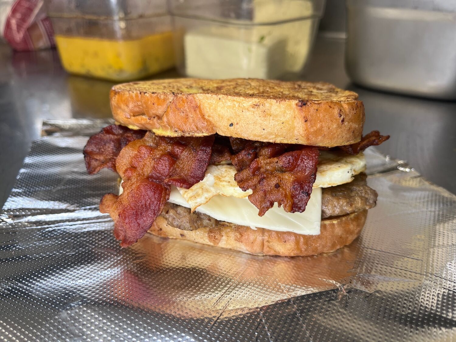 Slap Yo Self BBQ breakfast sandwich — bacon, sausage, egg, and cheese on Texas toast
