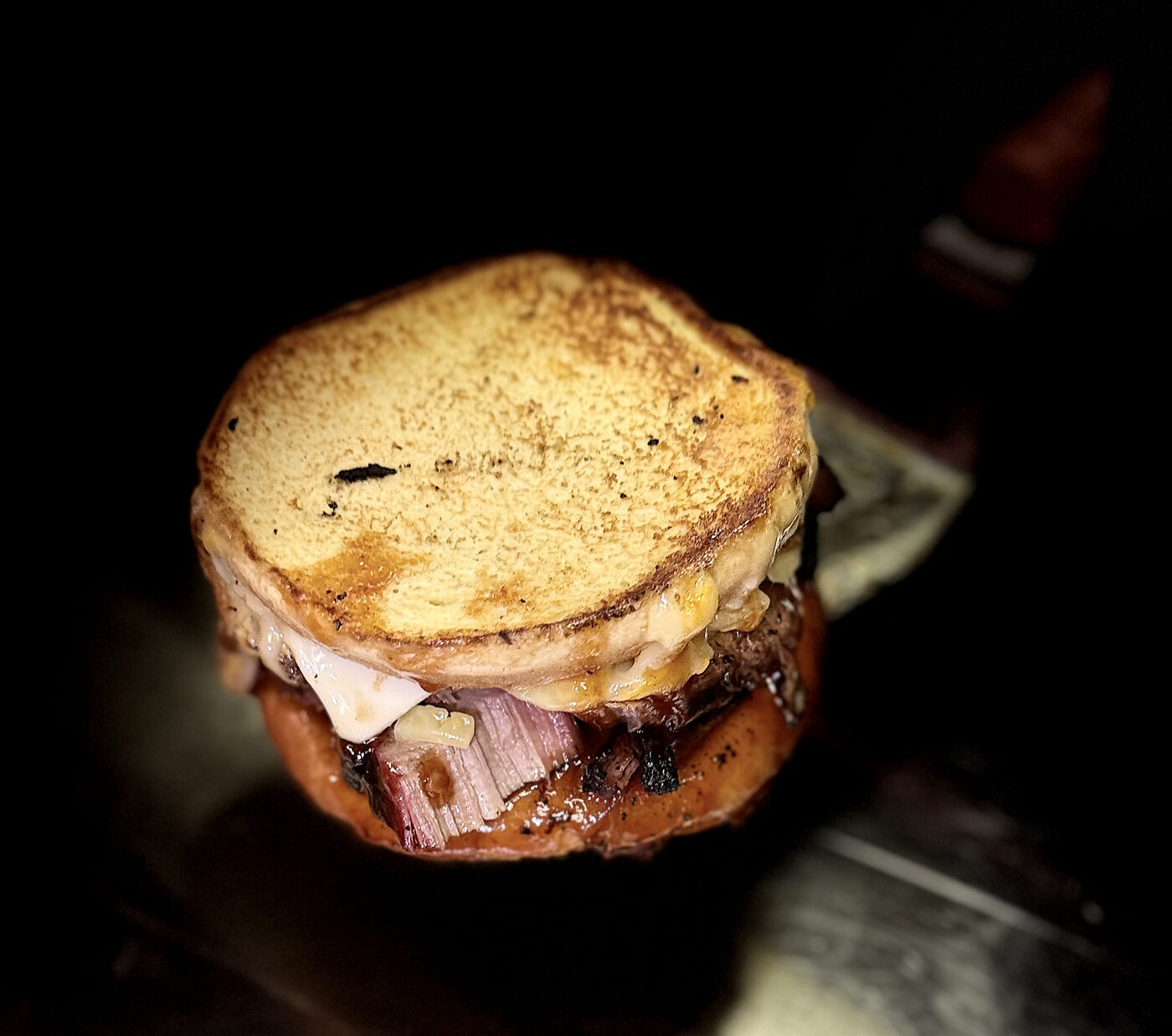 Brisket grilled cheese deluxe — slow-smoked brisket layered between griddled golden bread with melted gooey cheese at Slap Yo Self BBQ in Marion, Ohio