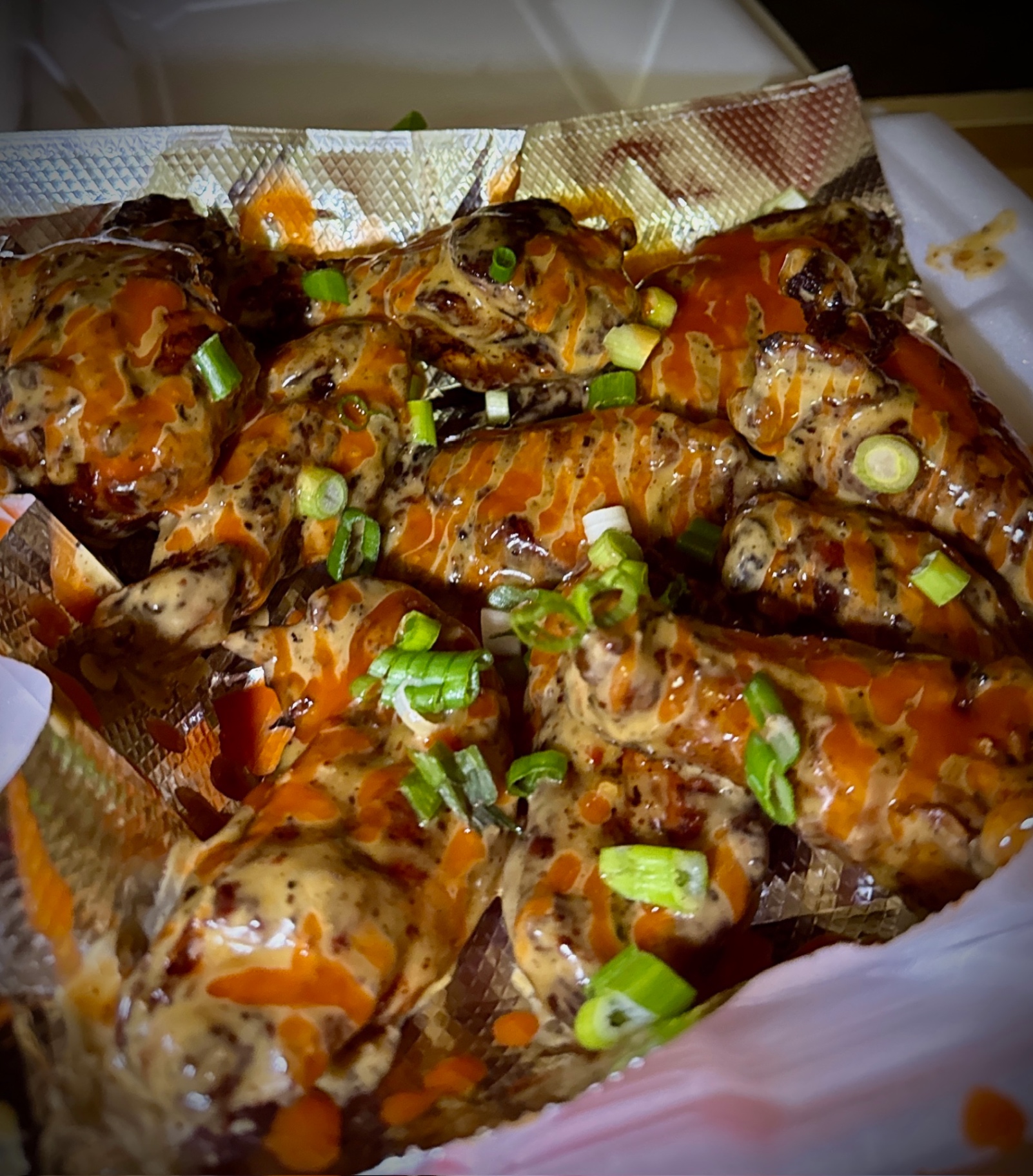Hot honey lemon pepper wings — award-winning crispy smoked wings tossed in sweet hot honey and lemon pepper sauce, topped with fresh scallions at Slap Yo Self BBQ in Marion, Ohio